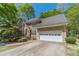 Exterior view showcasing the home's stone and stucco façade, complemented by the attached garage and paved driveway at 255 Sageglen Rd, Lawrenceville, GA 30044