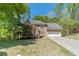 Stunning exterior showcasing the home's stone facade, mature trees, well-maintained lawn, and attached two-car garage at 255 Sageglen Rd, Lawrenceville, GA 30044