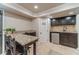 Basement kitchenette with dark cabinets, stainless steel appliances and granite countertops next to a dining table at 255 Sageglen Rd, Lawrenceville, GA 30044
