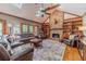 Inviting living room with stone fireplace, high ceilings, ceiling fan, skylights, and hardwood floors at 255 Sageglen Rd, Lawrenceville, GA 30044