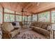 Inviting screened porch with wicker furniture and wooded views at 255 Sageglen Rd, Lawrenceville, GA 30044