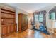 Sitting room features hardwood floors, bookshelf and an armoire at 255 Sageglen Rd, Lawrenceville, GA 30044