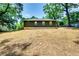 Exterior back view of home featuring a spacious backyard with mature trees at 3244 Mount Olive Rd, Atlanta, GA 30344