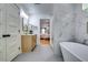 Bright bathroom with marble finishes, standalone tub, modern vanity, and view to connected bedroom at 3244 Mount Olive Rd, Atlanta, GA 30344