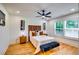Cozy bedroom with a king bed, bench, hardwood floors, and natural light at 3244 Mount Olive Rd, Atlanta, GA 30344