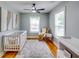 Well-lit Bedroom featuring hardwood floors and a white crib at 3244 Mount Olive Rd, Atlanta, GA 30344