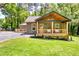 Charming home with a covered front porch, stylish lighting, and lush green lawn at 3244 Mount Olive Rd, Atlanta, GA 30344