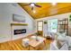 Bright living room with a modern fireplace, light-colored walls, and hardwood flooring at 3244 Mount Olive Rd, Atlanta, GA 30344