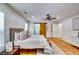 Bright main bedroom features wood floors, a ceiling fan, and stylish sliding wood door to ensuite at 3244 Mount Olive Rd, Atlanta, GA 30344