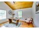 Bright home office with wood desk and hardwood floors under vaulted wood ceiling at 3244 Mount Olive Rd, Atlanta, GA 30344