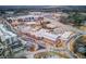 Wide aerial view of the vibrant community featuring modern apartments, commercial spaces, and outdoor amenities at 4414 Aldenham Way, Suwanee, GA 30024