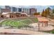 Outdoor amphitheater with lush green tiered seating and a covered stage, perfect for community events at 4414 Aldenham Way, Suwanee, GA 30024