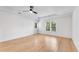 A spacious bedroom with hardwood flooring and a ceiling fan at 4414 Aldenham Way, Suwanee, GA 30024