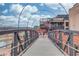 Modern pedestrian bridge offering scenic views of the surrounding community and river at 4414 Aldenham Way, Suwanee, GA 30024