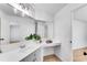 Bright bathroom with a white vanity, large mirror, and a plant adding a touch of greenery at 4414 Aldenham Way, Suwanee, GA 30024