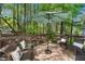 Inviting back deck with comfortable seating and a tranquil view of the surrounding greenery at 4414 Aldenham Way, Suwanee, GA 30024