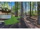 Beautiful backyard with a deck, lush greenery, mature trees, and a hammock at 4414 Aldenham Way, Suwanee, GA 30024