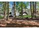 Relaxing backyard featuring mature trees, a deck, an inviting hammock, and comfortable outdoor seating at 4414 Aldenham Way, Suwanee, GA 30024