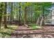 Private backyard with a deck, mature trees, lounge chair, and a hammock at 4414 Aldenham Way, Suwanee, GA 30024