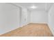 Large room in basement with hardwood floors, neutral white walls, and access to storage at 4414 Aldenham Way, Suwanee, GA 30024