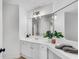 Bright bathroom featuring double mirrors, white cabinets, and modern lighting at 4414 Aldenham Way, Suwanee, GA 30024