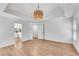 Large bedroom featuring an interesting light fixture and an ensuite bathroom at 4414 Aldenham Way, Suwanee, GA 30024