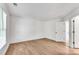 Bright bedroom with wood-look flooring, a large window, and neutral walls, creating a versatile and inviting space at 4414 Aldenham Way, Suwanee, GA 30024