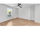 Bright bedroom with hardwood floors, ceiling fan, and large window at 4414 Aldenham Way, Suwanee, GA 30024
