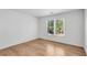 Bright bedroom with hardwood floors and large window for natural light at 4414 Aldenham Way, Suwanee, GA 30024
