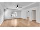 Large bedroom with tray ceiling, fan, hardwood floors, walk-in closet, and windows for plenty of natural light at 4414 Aldenham Way, Suwanee, GA 30024