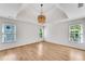 Spacious bedroom with tray ceiling, a modern light fixture, and lots of natural light at 4414 Aldenham Way, Suwanee, GA 30024