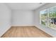 Bedroom featuring hardwood floors, a bright window, and neutral walls at 4414 Aldenham Way, Suwanee, GA 30024