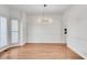 Dining room featuring a modern chandelier and ample natural light at 4414 Aldenham Way, Suwanee, GA 30024