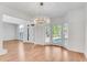 Bright dining room with elegant chandelier, bay window and wood floors at 4414 Aldenham Way, Suwanee, GA 30024