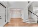 Stunning foyer featuring a modern chandelier, staircase, and wood floors at 4414 Aldenham Way, Suwanee, GA 30024