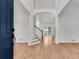 Inviting foyer featuring soaring ceilings, staircase, wood floors, and an abundance of natural light at 4414 Aldenham Way, Suwanee, GA 30024