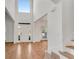 Gorgeous foyer with hardwood floors, soaring ceiling and a staircase with white risers at 4414 Aldenham Way, Suwanee, GA 30024