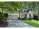 Charming two-story home with a two-car garage, manicured lawn and mature trees at 4414 Aldenham Way, Suwanee, GA 30024