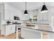 Beautiful kitchen featuring white cabinets, granite countertops and stainless steel appliances at 4414 Aldenham Way, Suwanee, GA 30024