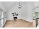 A spacious living room with lots of windows, hardwood floors, a fireplace and a modern chandelier at 4414 Aldenham Way, Suwanee, GA 30024