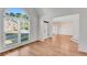 Open concept living room with a large window and light wood flooring at 4414 Aldenham Way, Suwanee, GA 30024