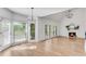 Inviting living room with fireplace, ample natural light, and wood flooring at 4414 Aldenham Way, Suwanee, GA 30024