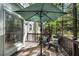 Relaxing outdoor patio area with seating, umbrella, and lush greenery at 4414 Aldenham Way, Suwanee, GA 30024