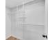 Walk-in closet features a hanging system with shelving at 4414 Aldenham Way, Suwanee, GA 30024