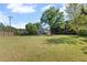 Spacious, grassy backyard with a partial view of the house and a tall fence, offering privacy at 4531 Cedar Dr, Loganville, GA 30052