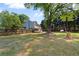 Large backyard featuring a swing set, mature trees, and a well-maintained lawn at 4531 Cedar Dr, Loganville, GA 30052