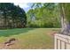 Expansive backyard with lush green grass and mature trees, perfect for outdoor activities at 4531 Cedar Dr, Loganville, GA 30052