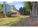 Backyard showing the deck, large trees, a fenced yard, and a patch for an outdoor firepit at 4531 Cedar Dr, Loganville, GA 30052