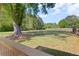 View of fenced backyard with a large tree, grass and a swing set for outdoor recreation at 4531 Cedar Dr, Loganville, GA 30052