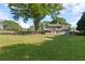 View of the large backyard showing the home's exterior, deck, swing set, and well-maintained lawn at 4531 Cedar Dr, Loganville, GA 30052